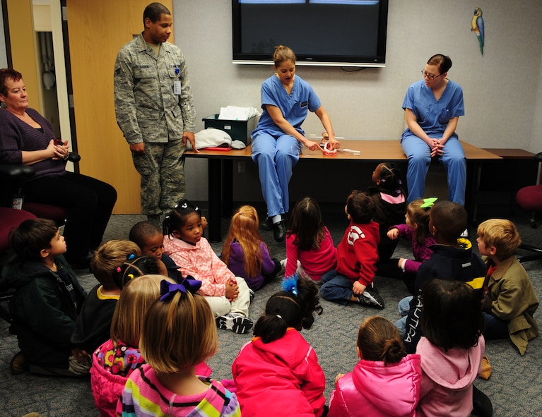 MOODY AIR FORCE BASE, Ga.-- Capt. Meghan Darby, 23rd Aeromedical Dental Squadron general dentist, teaches 4- and- 5-year-olds kids how to properly brush and floss their teeth by using a mouth model Feb. 1. February is Children’s Dental Health Month, so the dental clinic is educating children on proper hygiene, diet and regular dental visits. (U.S. Air Force photo/Senior Airman Stephanie Mancha)(RELEASED)