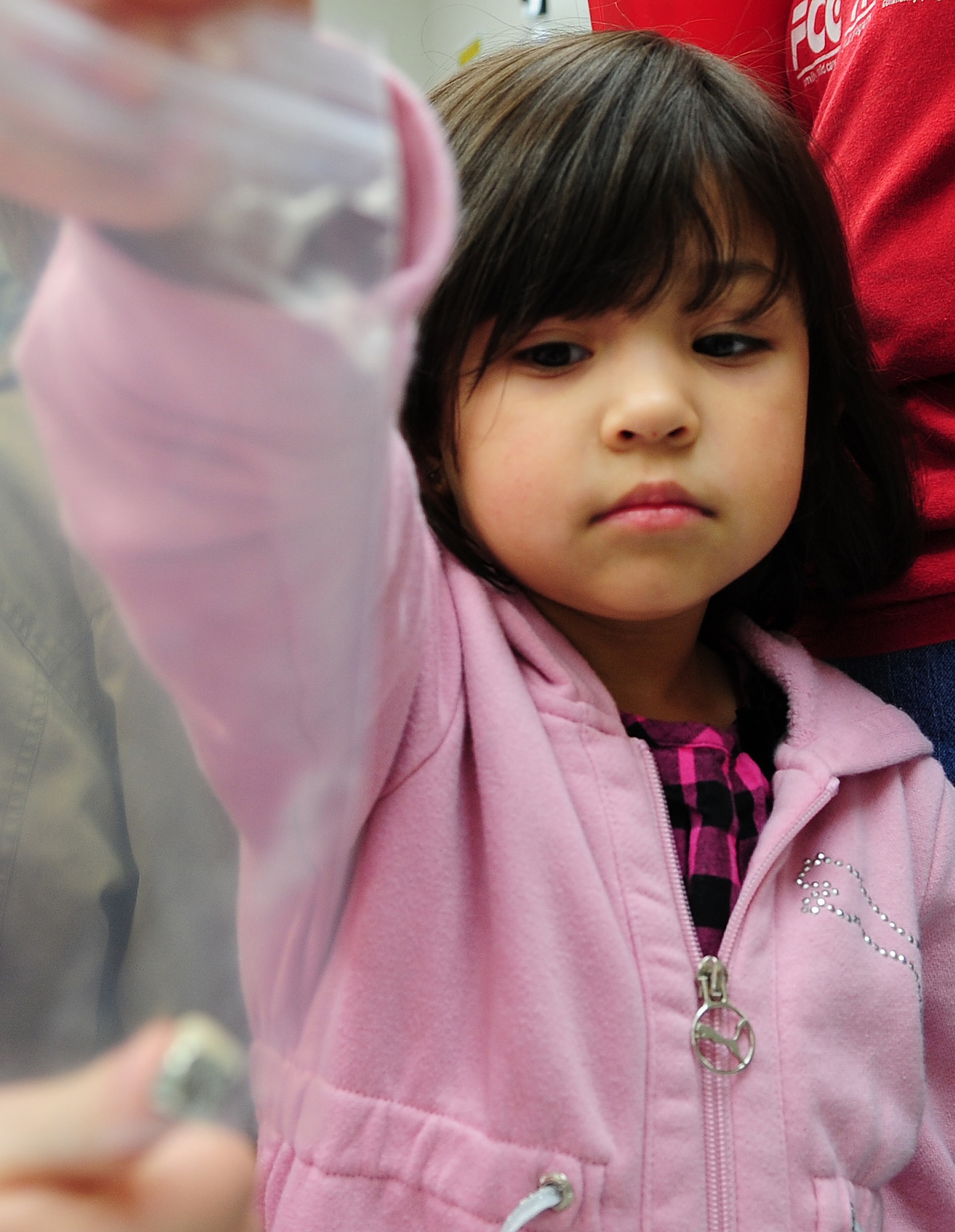 MOODY AIR FORCE BASE, Ga.-- Addison, daughter of Tech. Sgt. Ronnece Spencer, holds a silver dental cap Feb. 1. Dental caps are a type of restoration used to improve the strength of a tooth. (U.S. Air Force photo/Senior Airman Stephanie Mancha)(RELEASED)