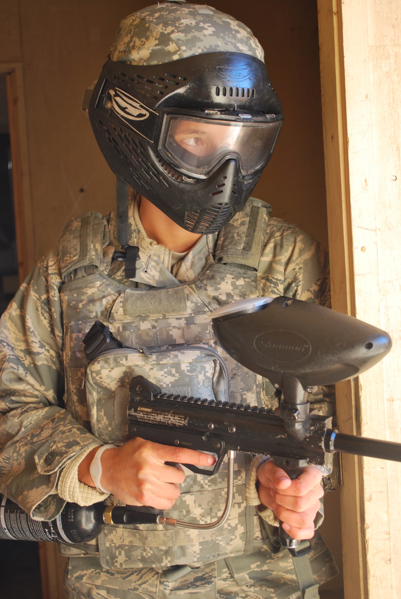 First Lt. Rhett Chase scans for aggressors as she guards a doorway during military operations in urban terrain training.  Chase is a contracting officer assigned to Headquarters Pacific Air Forces, Hickam AFB, Hawaii.  She and 22 other contracting airmen participated in Operation Joint Dawn 2011, a U.S. Army Expeditionary Contracting Command pre-deployment exercise held at Fort Campbell, Ky.  (U.S. Army Photo by Ed Worley)