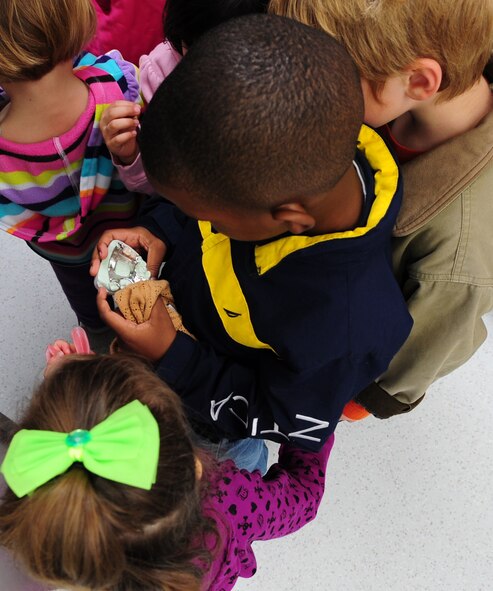 MOODY AIR FORCE BASE, Ga.-- Darius, son of Senior Master Sgt. Cheryl Moye and Master Sgt. Darryl Moye, examines teeth moldings Feb. 1. The 4- and 5-year-olds from the CDC were given a tour of the dental clinic. (U.S. Air Force photo/Senior Airman Stephanie Mancha)(RELEASED)
