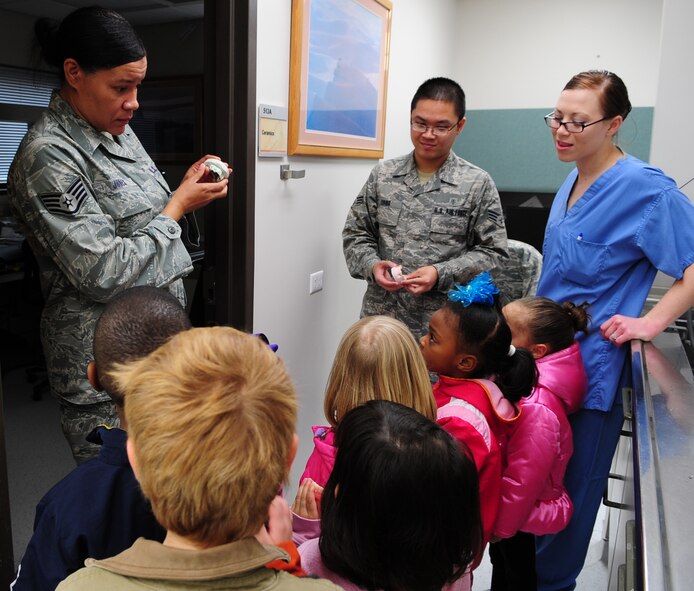 MOODY AIR FORCE BASE, Ga.-- Staff Sgt. Zsanine Jones, 23rd Aeromedical Dental Squadron dental laboratory craftsman, explains how teeth moldings are made Feb. 1. The children enjoyed being able to hold the teeth molding after learning about them. (U.S. Air Force photo/Senior Airman Stephanie Mancha)(RELEASED)