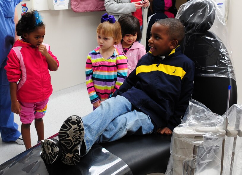 MOODY AIR FORCE BASE, Ga.-- Darius, son of Senior Master Sgt. Cheryl Moye and Master Sgt. Darryl Moye, tests out a dentist chair Feb. 1. All the children were given a chance to sit in the chair and try out all the features. (U.S. Air Force photo/Senior Airman Stephanie Mancha)(RELEASED)