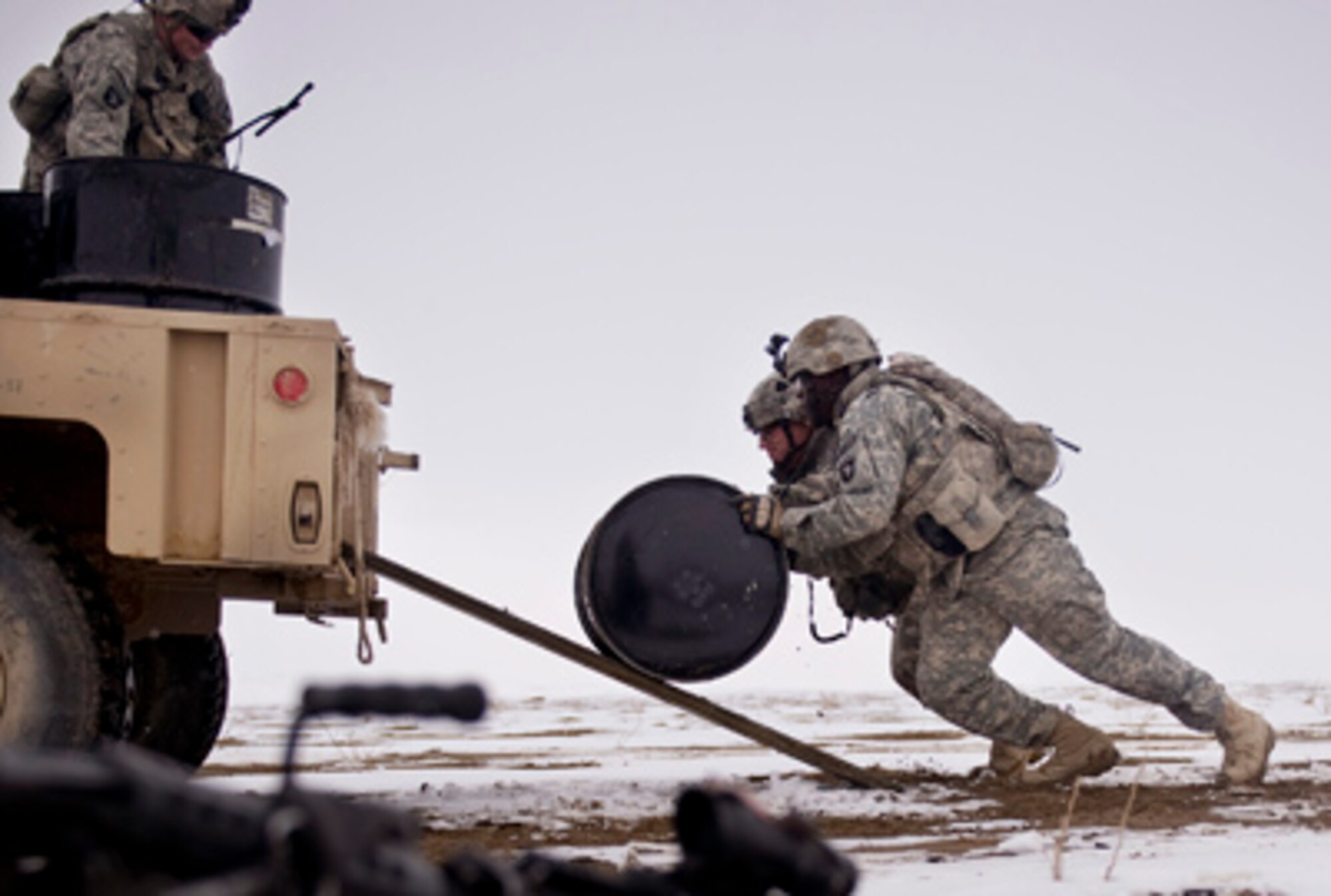 Soldiers from Task Force Currahee, 4th Brigade, 101st Airborne Division, recover bundles of fuel that were air delivered recently to Forward Operating Base Waza K'wah in the Paktika province of Afghanistan via a C-17 Globemaster III. The fuel was delivered to help sustain members of Task Force Currahee, whose only means of re-supply is through air delivery. (U.S. Air Force photo/Master Sgt. Adrian Cadiz) 
