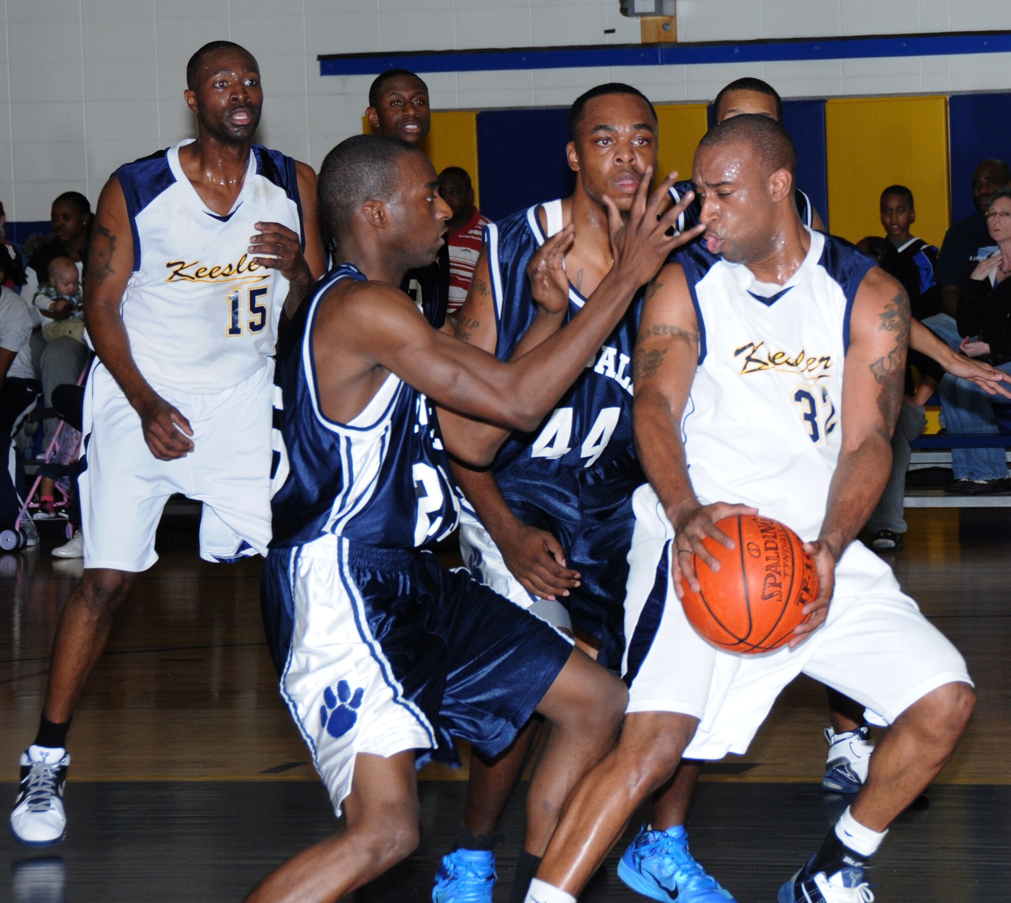 From left, Tyndall Tigers Jonathan Lee and Marquez Armour surround Keesler’s Sherrod Brown as he searches for a fellow Dragon clear to receive a pass during Saturday’s game. Keesler won, 72-68.  (U.S. Air Force photo by Kemberly Groue)
