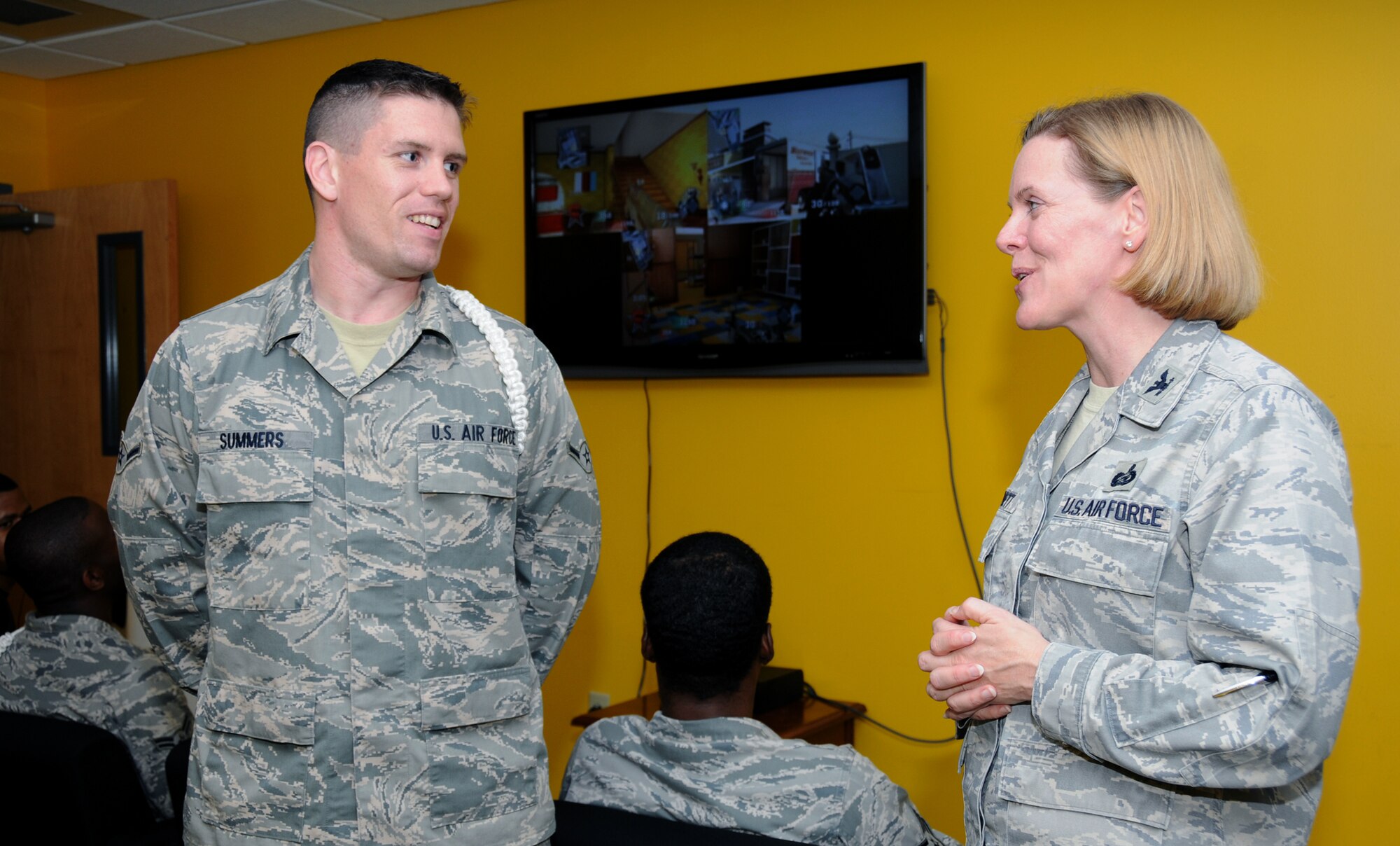 Airman Jason Summers, a student in the 338th Training Squadron who serves as a
“white rope” chaplain assistant, chats with Col. Lynn Connett as she checks out the new video room in the Fishbowl Student Center inside the Levitow Training Support Facility. Colonel Connett is commander of the 81st Training Group.  The video room provides about 10 different gaming systems for students to enjoy.  (U.S. Air Force photo by Kemberly Groue)