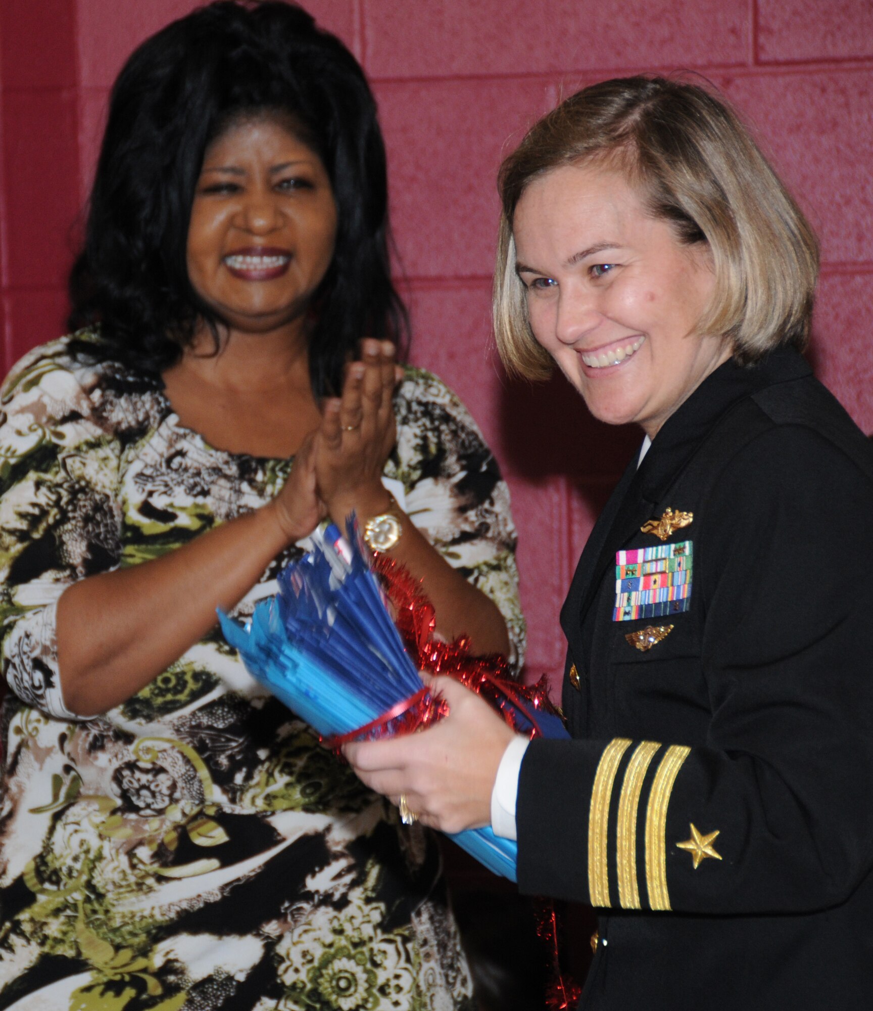 Gorenflo Elementary School Principal Melissa Nance, left, presents handmade thank-you cards to Cmdr. Angie Walker, CNATTU commander, in recognition of the unit’s support during a reaffirmation ceremony at the school Friday.  (U.S. Air Force photo by Kemberly Groue)