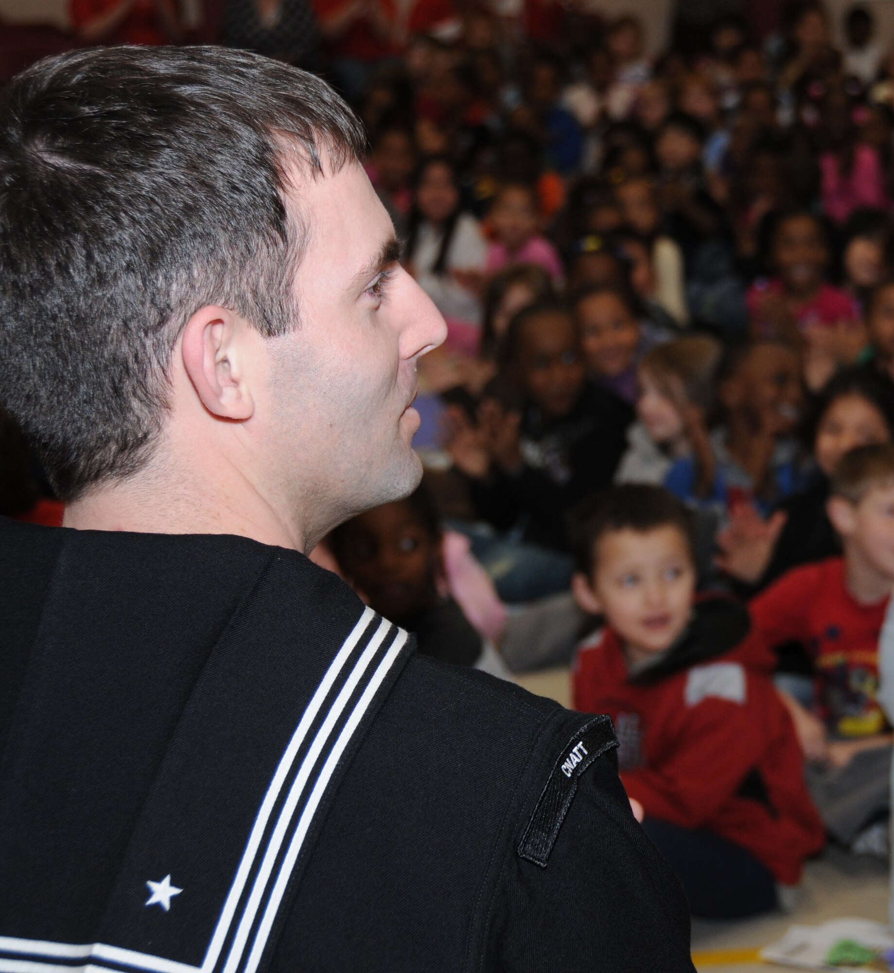 Aerographer’s Mate 1st Class Michael Giardini surveys the students assembled for CNATTU’s reaffirmation ceremony Friday at Gorenflo Elementary School in Biloxi.  (U.S. Air Force photo by Kemberly Groue)