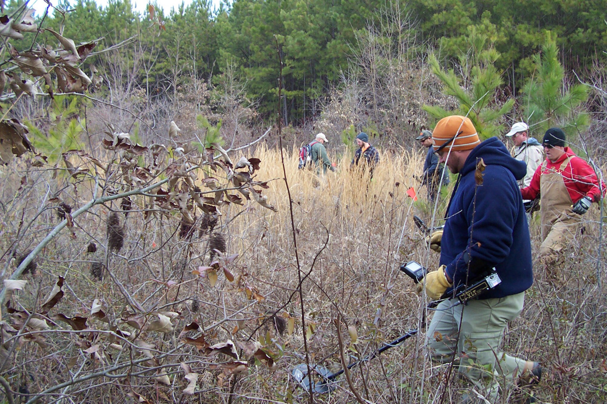 Members of Bay West, Inc. sweep a recreation trail at Arnold Engineering Development Center for possible unexploded ordnance (UXO). The crew hopes to have a project to find unexploded practice mines finished by the end of February. (Photo provided)