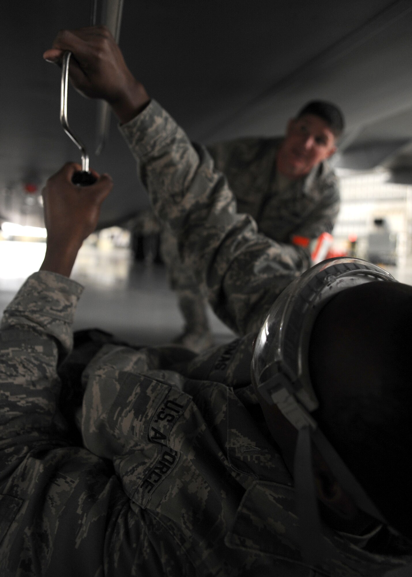 Tech. Sgt. Jonathan Wilson watches Airman 1st Class Antonio Thomas change an ultra high frequency antenna during a personal evaluation inspection at the home station check hangar, here Feb. 1.  The 437th Maintenance Group, the 315th Maintenance Group and the 628th Logistics Readiness Squadron are preparing for a Logistics Compliance Assessment Program inspection scheduled for Feb. 4.  Sergeant Wilson is a quality assurance inspector with the 437th Maintenance Operations Squadron and Airman Thomas is a communications navigation specialist with the 437th Aircraft Maintenance Squadron. (U.S. Air Force photo/Senior Airman Katie Gieratz)(RELEASED)

