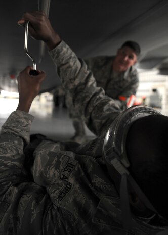 Tech. Sgt. Jonathan Wilson watches Airman 1st Class Antonio Thomas change an ultra high frequency antenna during a personal evaluation inspection at the home station check hangar, here Feb. 1.  The 437th Maintenance Group, the 315th Maintenance Group and the 628th Logistics Readiness Squadron are preparing for a Logistics Compliance Assessment Program inspection scheduled for Feb. 4.  Sergeant Wilson is a quality assurance inspector with the 437th Maintenance Operations Squadron and Airman Thomas is a communications navigation specialist with the 437th Aircraft Maintenance Squadron. (U.S. Air Force photo/Senior Airman Katie Gieratz)(RELEASED)

