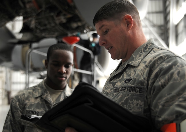 Tech. Sgt. Jonathan Wilson speaks with Airman 1st Class Antonio Thomas during a personal evaluation inspection here Feb. 1 in preparation for the Logistics Compliance Assessment Program inspection Feb. 4. The 437th Maintenance Group, the 315th Maintenance Group and the 628th Logistics Readiness Squadron will be inspected by a team of 52 LCAP inspectors.  Sergeant Wilson is a quality assurance inspector with the 437th Maintenance Operations Squadron and Airman Thomas is a communications navigation specialist with the 437th Aircraft Maintenance Squadron. (U.S. Air Force photo/Senior Airman Katie Gieratz)