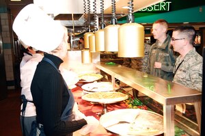LANGLEY AIR FORCE BASE, Va.—Secretaries from around base wait for Airman to select their pizza from the Eagle Room Dining Facility Jan. 27.  Each month, base secretaries serve Airman at the Eagle Room Dining Facility to show their appreciation for the Airman.  (U.S. Air Force photo/Airman 1st Class Kayla Newman)(Released)