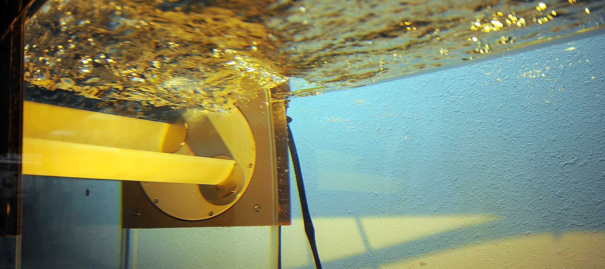 A wave energy converter generates power in a tank at the AIr Force Academy Jan. 27, 2010. The converter was designed by Department of Astronautics researchers Dr. Stefan Siegel and Jurgen Seidel. (U.S. Air Force photo/Rachel Boettcher)