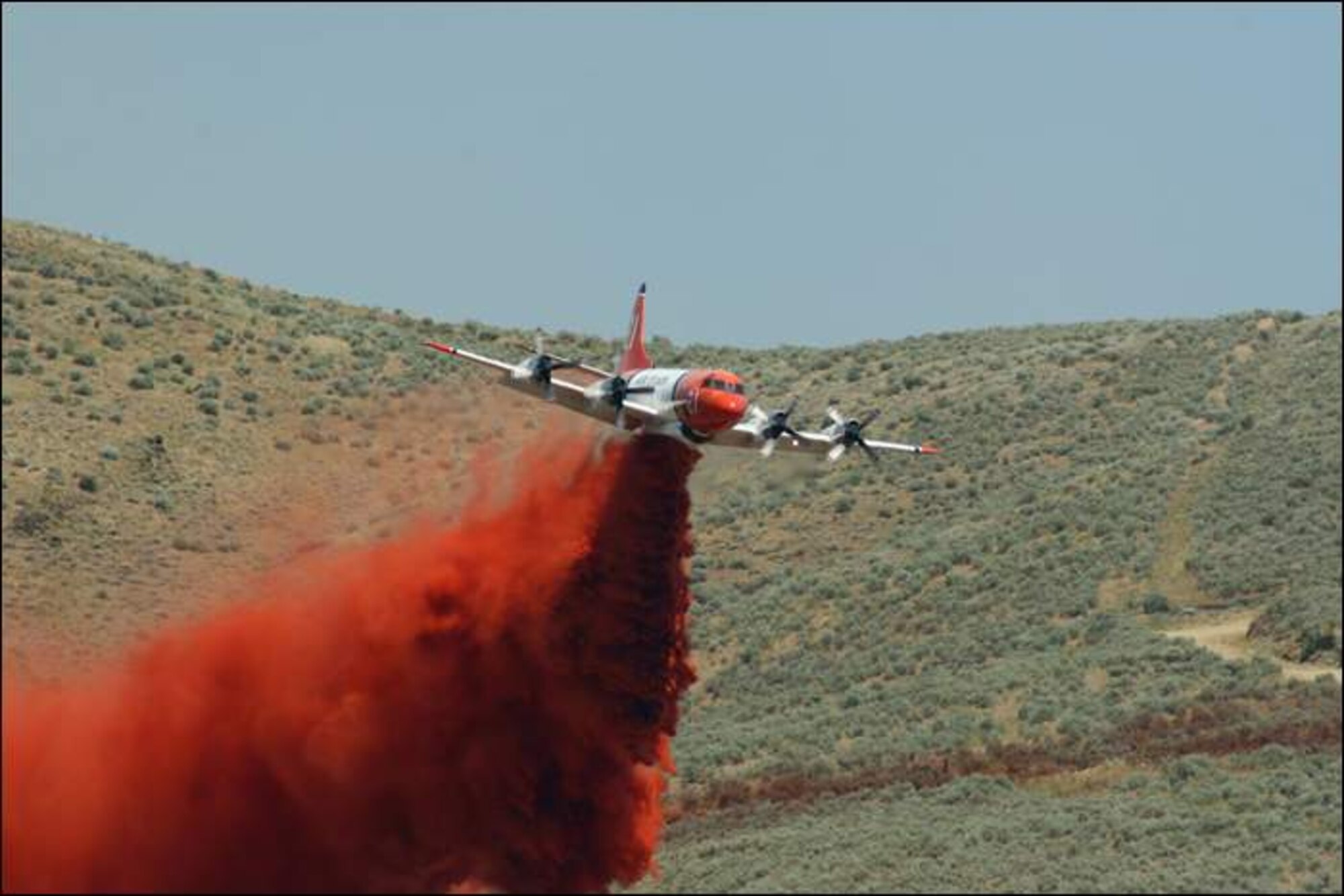 Aero Union’s P-3s, modified by the company for firefighting, travel around the country dumping thousands of gallons of red-dyed Phos-chek on wildfires. (Photo courtesy of Aero Union)