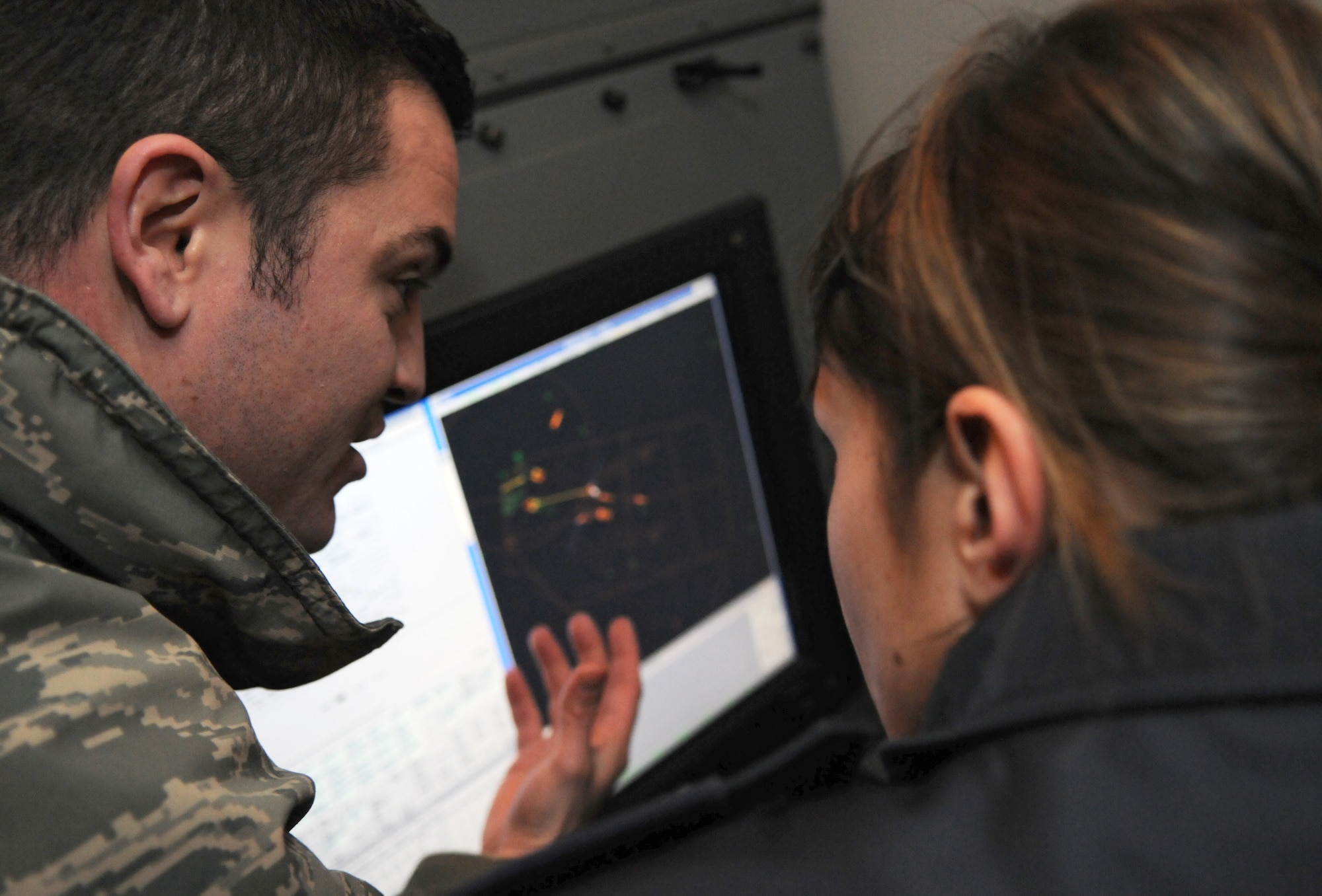 SPANGDAHLEM AIR BASE, Germany – Tech. Sgt. Jorel Justus, 606th Air Control Squadron weapons director, talks with 1st Lt. Romy Heinze, German air force weapons controller, about the equipment systems the 606th Air Control Squadron uses to communicate with pilots Jan. 31. Lieutenant Heinze and seven other German air force members visited the 606th ACS for briefings and interactive opportunities as they train to become combat ready aircraft controllers at the Tactical Air Command and Control Training Section in Meßstetten, Germany. (U.S. Air Force photo/Airman 1st Class Matthew B. Fredericks)
