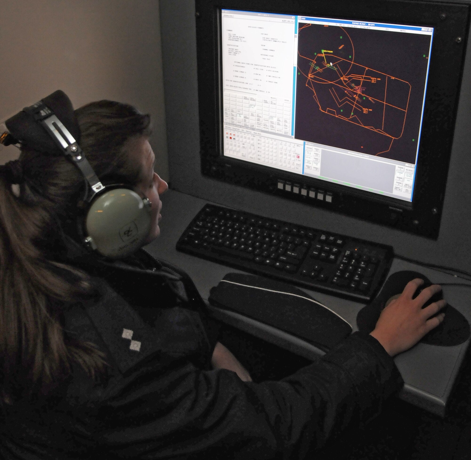 SPANGDAHLEM AIR BASE, Germany – 1st Lt. Julia Sauter, German air force weapons controller, listens to communications between the 606th Air Control Squadron and pilots during a training mission Jan. 31. Lieutenant Sauter and seven other German air force members visited the 606th ACS for briefings and interactive opportunities as they train to become combat-ready aircraft controllers at the Tactical Air Command and Control Training Section in Meßstetten, Germany. (U.S. Air Force photo/Airman 1st Class Matthew B. Fredericks)