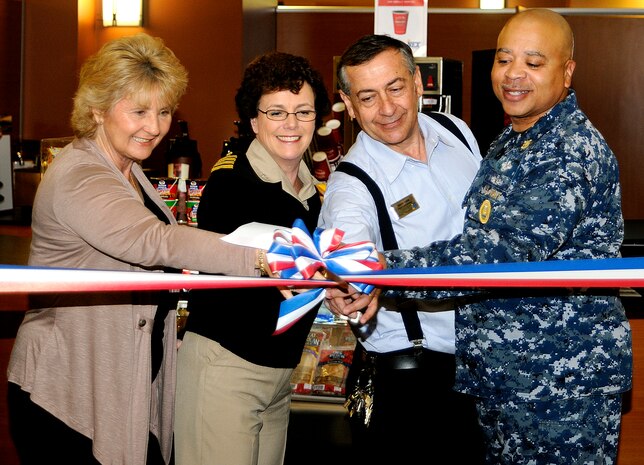 At the grand opening, (left to right) Beth Munoz, general manager Navy Exchange Charleston, Capt. Paula McClure, commanding officer Naval Health Clinic Charleston, Doug Yaxis, area vending manager for the NEX and NHCC Command Master Chief Terence Anthony cut the ribbon for the grab-n-go coffee kiosk at NHCC on Joint Base Charleston-Weapons Station, Jan. 31. The grab-n-go, the first of its kind offered by the NEX, provides coffee and snacks to patrons and staff members at NHCC. (U.S. Navy photo/Machinist's Mate 3rd Class Brannon Deugan)