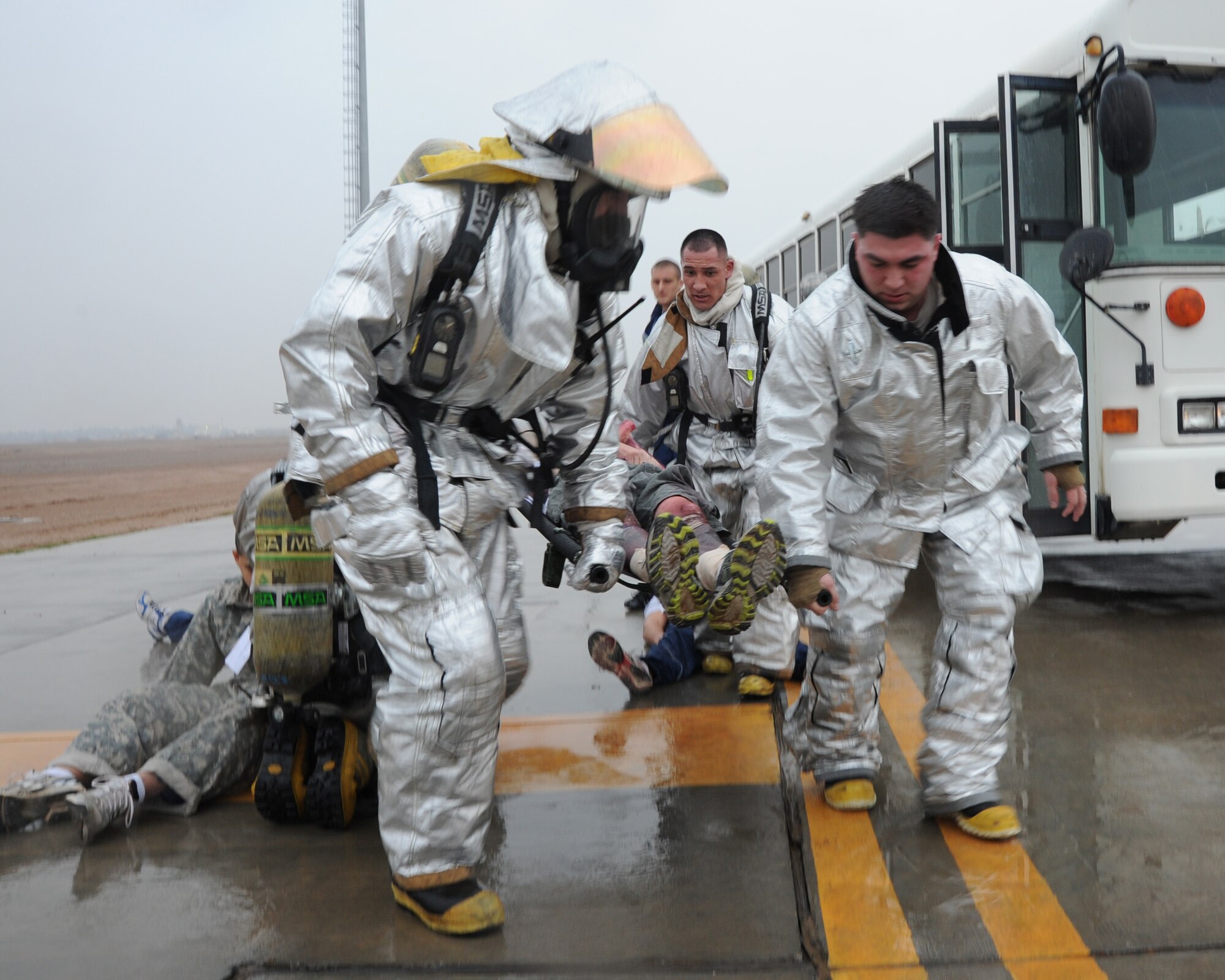 JOINT BASE BALAD, Iraq-- Firefighters from the 332nd Expeditionary Civil Engineer Squadron transport a litter patient during a mass casualty exercise Jan. 29, 2011. The 332nd Expeditionary Medical Group conducted the exercise to practice response skills. (U.S. Air Force photo/ Staff Sgt. Keyonna Fennell)