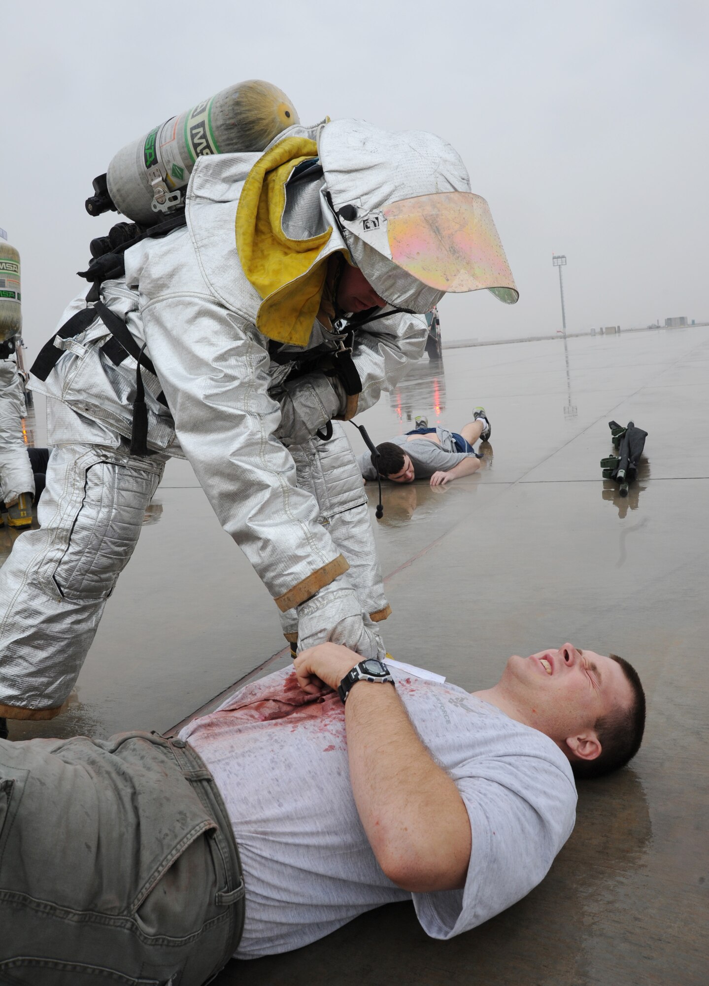 JOINT BASE BALAD, Iraq-- A 332nd Expeditionary Civil Engineer Squadron firefighter responds to a simulated injury on the flightline Jan. 29, 2011. The scenario was part of a mass casualty exercise held by the 332nd Expeditionary Medical Group to practice response skills. (U.S. Air Force photo/Staff Sgt. Keyonna Fennell)