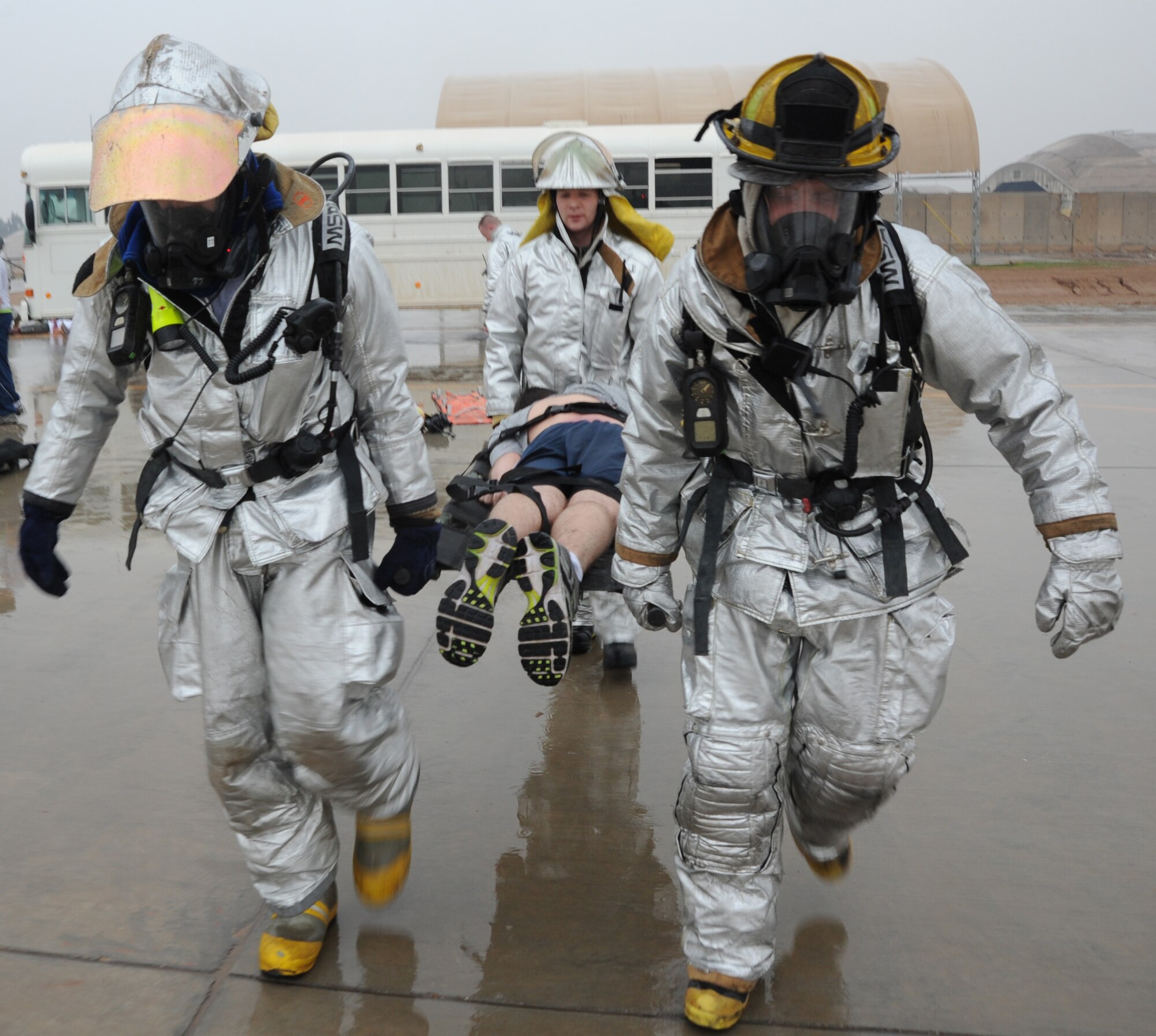 JOINT BASE BALAD, Iraq-- Firefighters from the 332nd Expeditionary Civil Engineer Squadron transport a litter patient during a mass casualty exercise Jan. 29, 2011. The 332nd Expeditionary Medical Group conducted the exercise to practice response skills. (U.S. Air Force photo/ Staff Sgt. Keyonna Fennell)