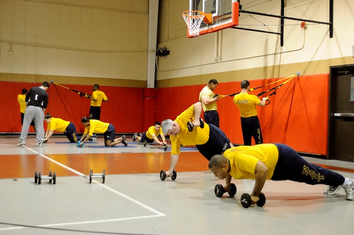 Sailors at Naval Support Activity improve their overall physical health by going through circuit training provided by physical trainer Riley Phelps, during a morning group PT session at Joint Base Charleston-Weapons Station, Jan. 28. Circuit training allows personnel to focus on a specific muscle group through various workouts which will help build endurance over time. (U.S. Navy photo/Mass Communication Specialist 1st Class Jennifer Hudson)