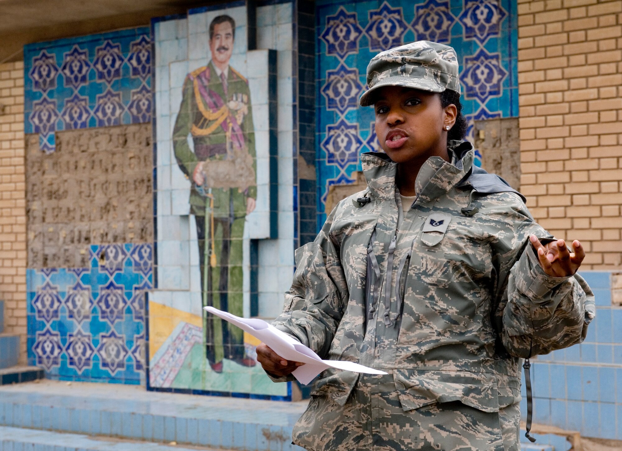 U.S. Staff Sgt. Angela Ward, 447th Air Expeditionary Group chaplains assistant, talks about Saddam Hussein during a tour of historic buildings at Baghdad, Jan. 29. The Sather Air Base Chapel runs tours of historic sites on a regular basis.  (U.S. Air Force photo by Staff Sgt. Levi Riendeau)