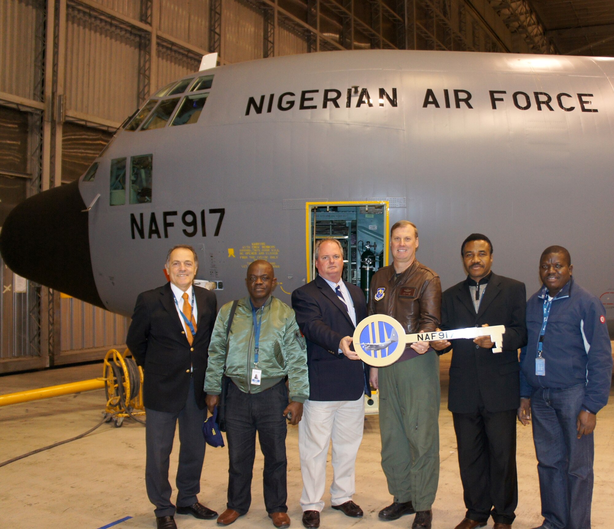 LISBON, Portugal - The ceremonial key to the first of five refurbished
C-130H aircraft is being handed back to the Nigerian Air Force Jan. 26 after
more than a year in depot maintenance. Seventeenth Air Force (Air Forces
Africa) is orchestrating the capacity-building activity with its partner
nation, which includes an extensive maintenance process to upgrade their
fleet. (Courtesy photo)
