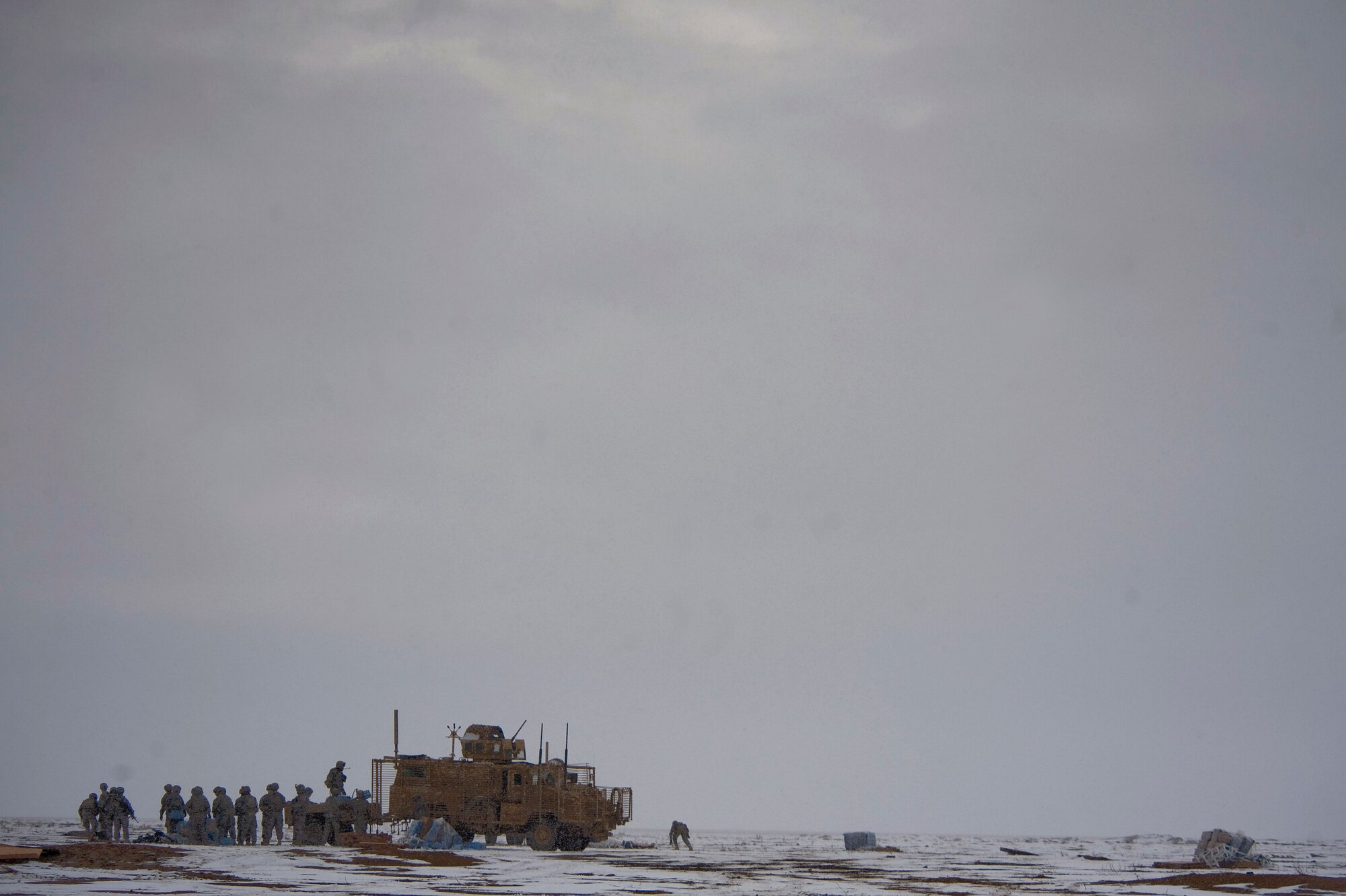 Soldiers from Task Force Currahee, 4th Brigade, 101st Airborne Division, recover bundles of fuel that were air delivered to Forward Operating Base Waza K'wah in the Paktika province of Afghanistan via a C-17 Globemaster III. The fuel was delivered to help sustain members of Task Force Currahee whose only means of re-supply is through air delivery. Members of Task Force Currahee recovered the bundles despite the inclement weather. (U.S. Air Force photo by Master Sgt. Adrian Cadiz)