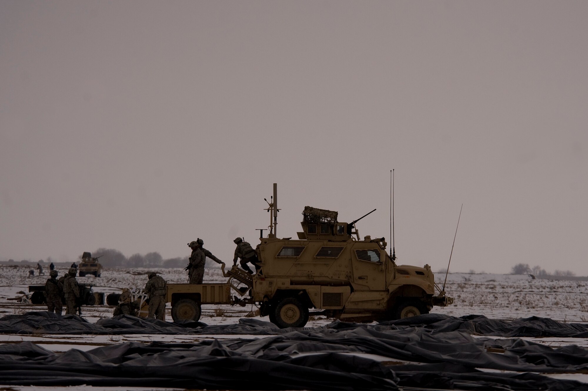 Soldiers from Task Force Currahee, 4th Brigade, 101st Airborne Division, recover bundles of fuel that were air delivered to Forward Operating Base Waza K'wah in the Paktika province of Afghanistan via a C-17 Globemaster III. The fuel was delivered to help sustain members of Task Force Currahee whose only means of re-supply is through air delivery. (U.S. Air Force photo by Master Sgt. Adrian Cadiz)
