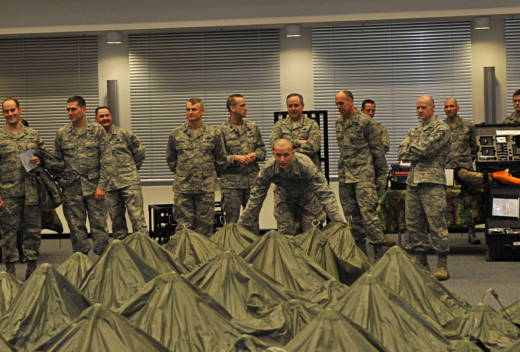 RAMSTEIN AIR BASE, Germany - Gen. Mark A. Welsh III, U.S. Air Forces in Europe commander, and Chief Master Sgt. David Williamson, USAFE command chief, view a DRASH tent demonstration by Airmen of the 435th Contingency Response Group, Jan. 28, 2011. General Welsh and Chief Williamson spent the day visiting the facilities of the 435th Air Ground Operations Wing. (U.S. Air Force photo by Airman 1st Class Desiree Esposito)