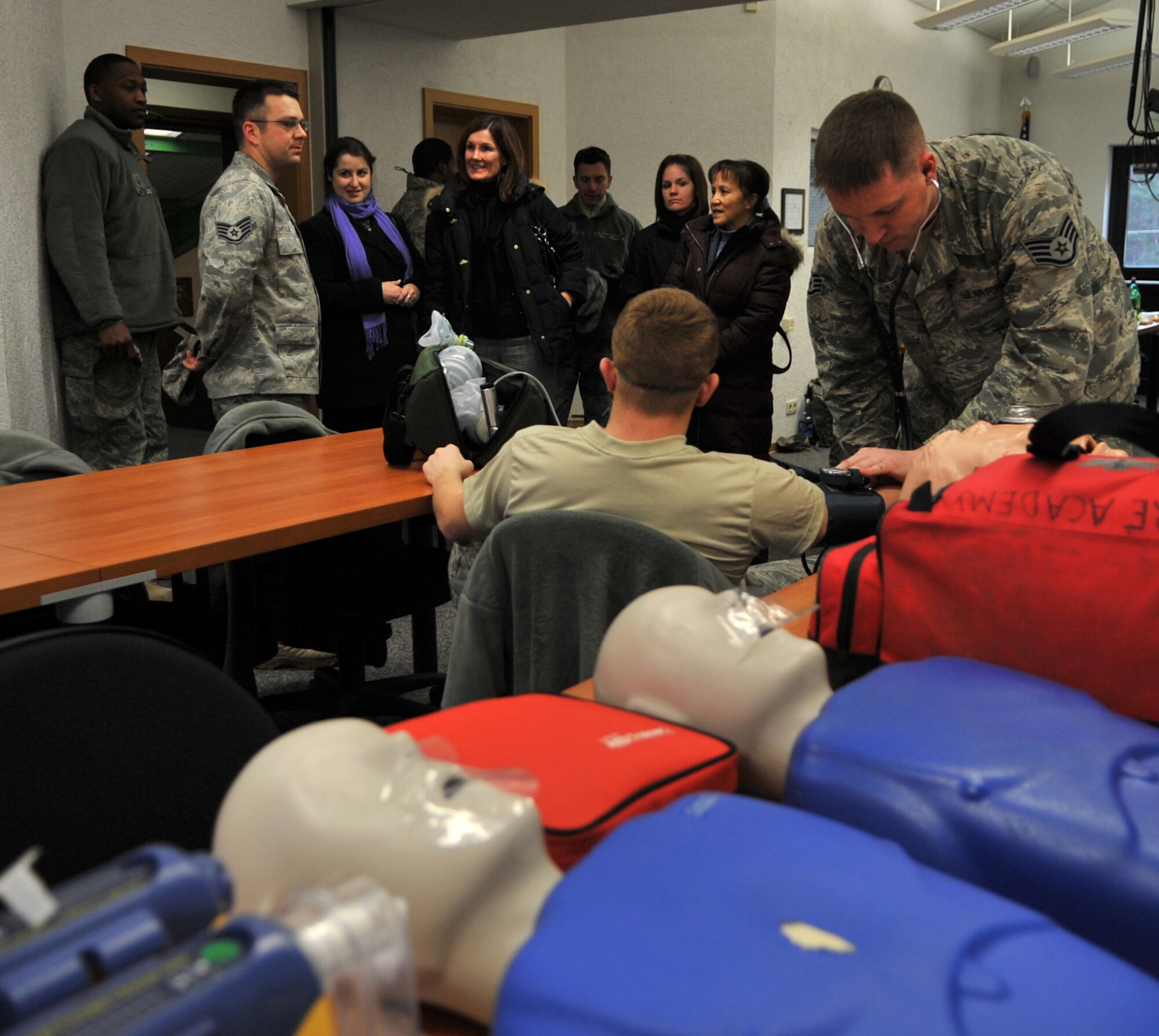 RAMSTEIN AIR BASE, Germany - Staff Sgt. Ron Lee, 435th Construction and Training Squadron fire academy instructor, gives a tour of a CTS compound emergency medical technician class to Betty Welsh (center), wife of Gen. Mark A. Welsh III, U.S. Air Forces in Europe commander, and a group of commander and command chief spouses during an immersion, Jan. 28, 2011. Also on the tour were Laura Shapland, wife of 435th Air Ground Operations Wing Commander Col. John Shapland; Mary Williamson, wife of USAFE Command Chief Master Sgt. Dave Williamson; and Margie Stippel, wife of 435th AGOW Command Chief Master Sgt. Mitch Stippel. (U.S. Air Force photo by Senior Airman Caleb Pierce)