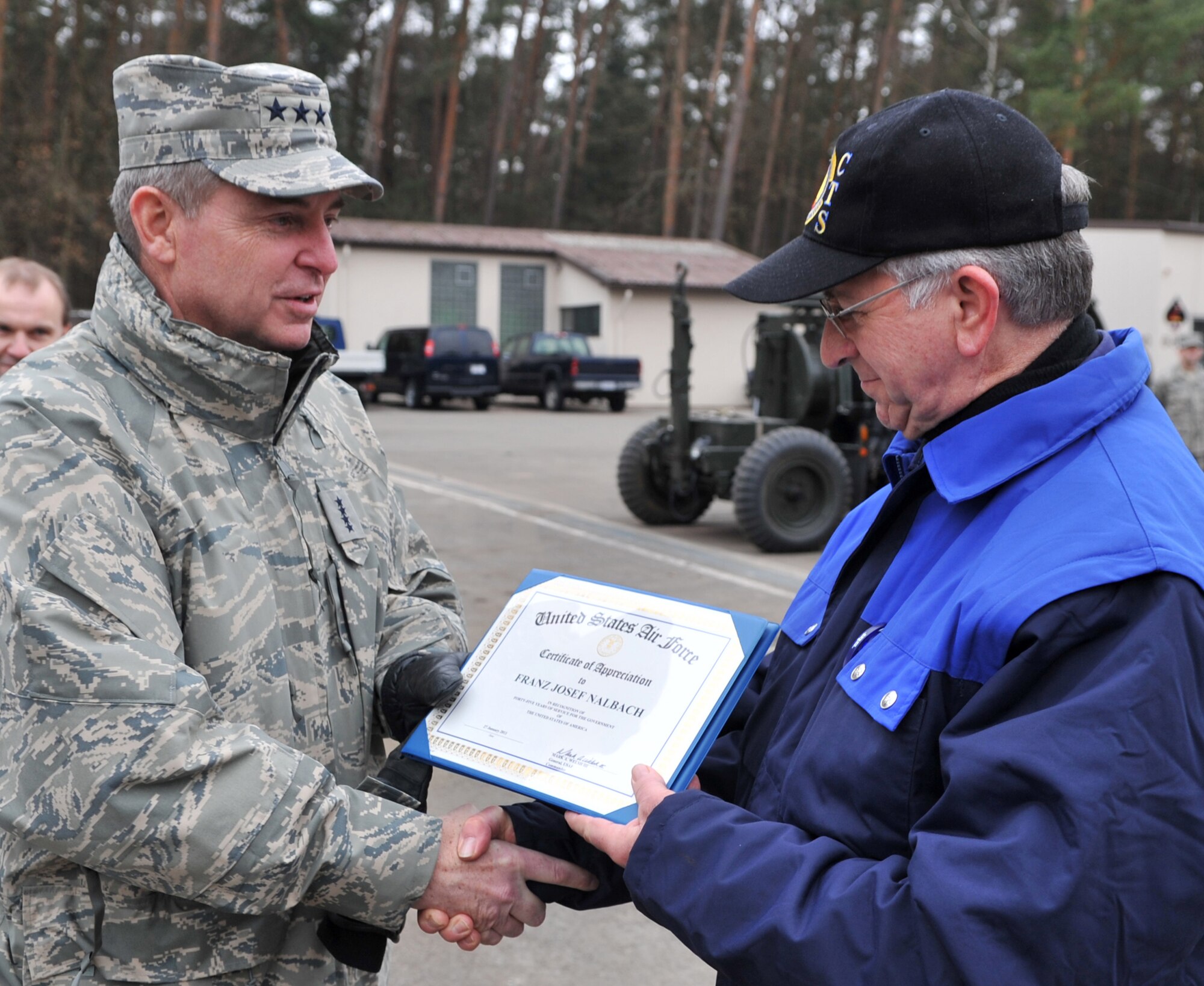 RAMSTEIN AIR BASE, Germany - Gen. Mark A. Welsh III, U.S. Air Forces in Europe commander, presents Franz Josef Nalbach a certificate of appreciation during an immersion visit with the 435th Construction and Training Squadron, Jan. 28, 2011. The certificate was given to recognize 45 years of service to the government of the United States of America. (U.S. Air Force photo by Senior Airman Caleb Pierce)