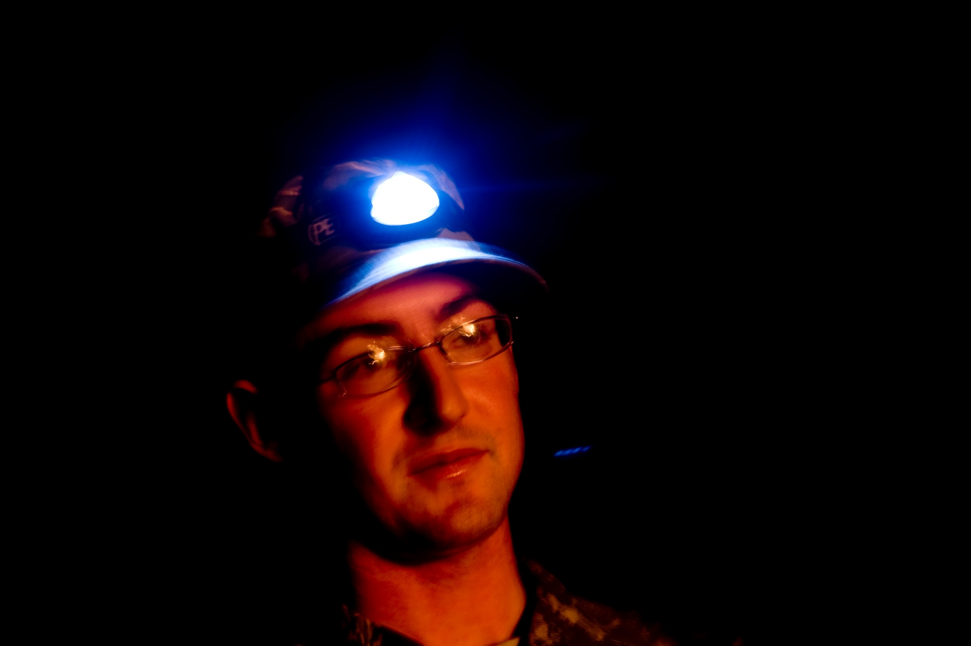 Senior Airman Michael Kushma, deployed from the 1st Combat Communications Squadron at Ramstein Air Base, Germany, stands near a bonfire in order to stay warm at Forward Operating Base Waza K'wah, Paktika province, Afghanistan.The bonfire is a weekly ritual where both Army and Air Force members gather together to relax and enjoy each others company and help lift morale. Senior Airman Kushma is one of four Airmen assigned to the FOB to help provide communications support. (U.S. Air Force photo by Master Sgt. Adrian Cadiz)