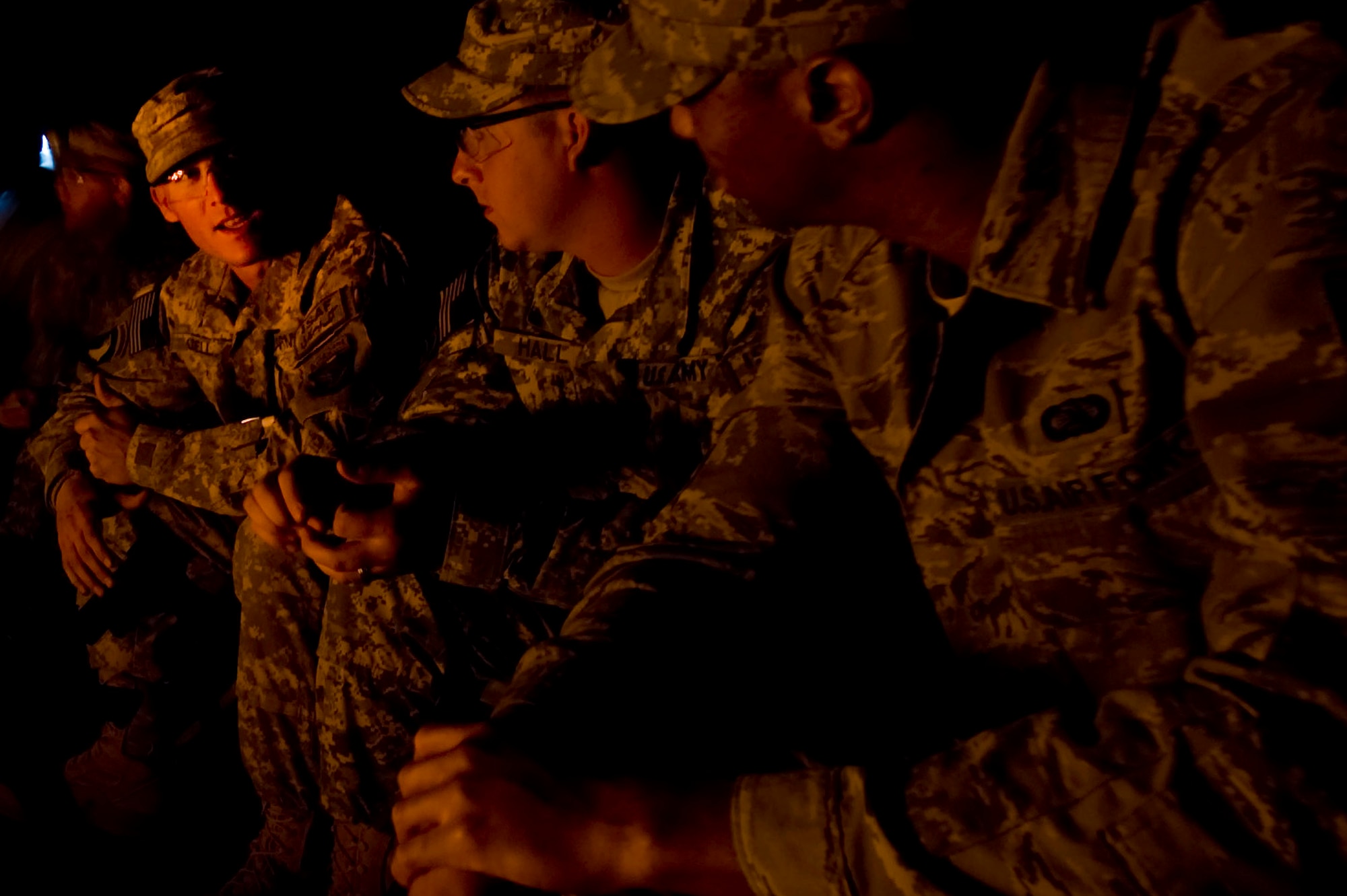 Staff Sgt. Dustin Hall and  Sgt. Robert Odell Task Force Currahee, 4th Brigade, 101st Airborne Division, sit and chat with Senior Airman Mychael White, deployed from the 56th Communications Squadron at Luke AFB, Ariz, while they warm up at a bonfire at Forward Operating Base Waza K'wah, Paktika province, Afghanistan.The bonfire is a weekly ritual where both Army and Air Force members gather together to relax and enjoy each others company and help lift morale. Senior Airman White is one of four Air Force members assigned to the FOB for communications support. (U.S. Air Force photo by Master Sgt. Adrian Cadiz)
