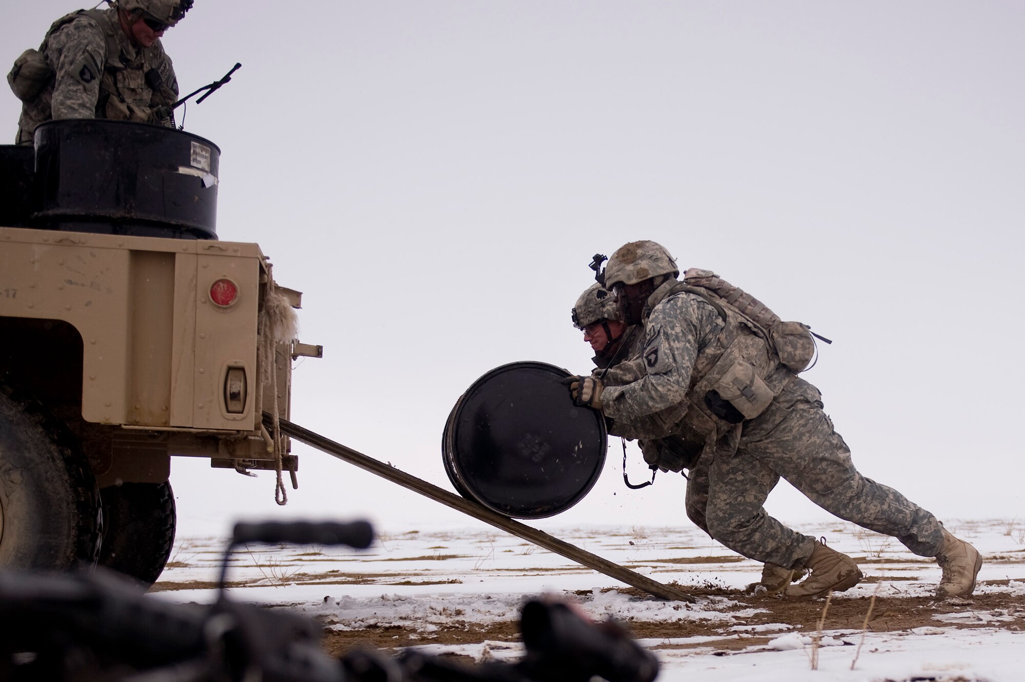 Soldiers from Task Force Currahee, 4th Brigade, 101st Airborne Division, recover bundles of fuel that were air delivered to Forward Operating Base Waza K'wah in the Paktika province of Afghanistan via a C-17 Globemaster III. The fuel was delivered to help sustain members of Task Force Currahee whose only means of re-supply is through air delivery. (U.S. Air Force photo by Master Sgt. Adrian Cadiz)
