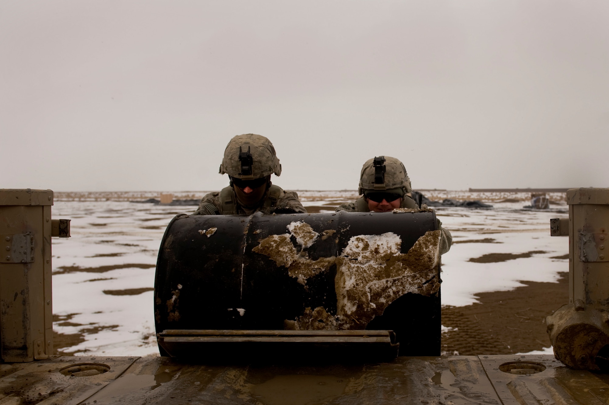 Soldiers from Task Force Currahee, 4th Brigade, 101st Airborne Division, help recover a  barrel of fuel that was air delivered to Forward Operating Base Waza K'wah in the Paktika province of Afghanistan via a C-17 Globemaster III. The fuel was delivered to help sustain members of Task Force Currahee whose only means of re-supply is through air delivery. (U.S. Air Force photo by Master Sgt. Adrian Cadiz)