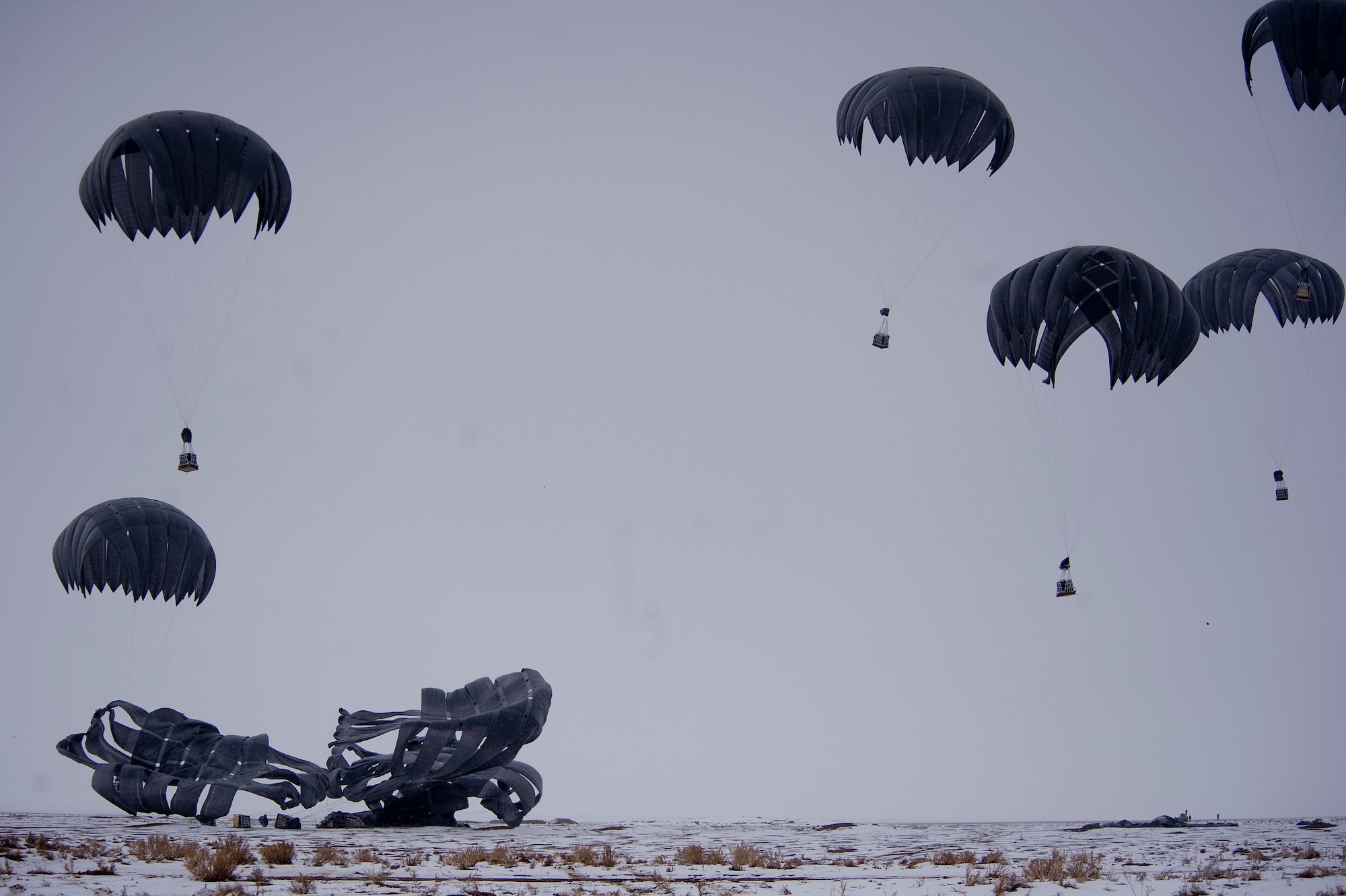 Bundles of fuel are air delivered to Forward Operating Base Waza K'wah in the Paktika province of Afghanistan. The fuel was part of a C-17 Globemaster III air delivery to help sustain members of Task Force Currahee, 4th Brigade Combat Team, 101st Airborne Division, whose only means of re-supply is through air delivery. (U.S. Air Force photo by Master Sgt. Adrian Cadiz)