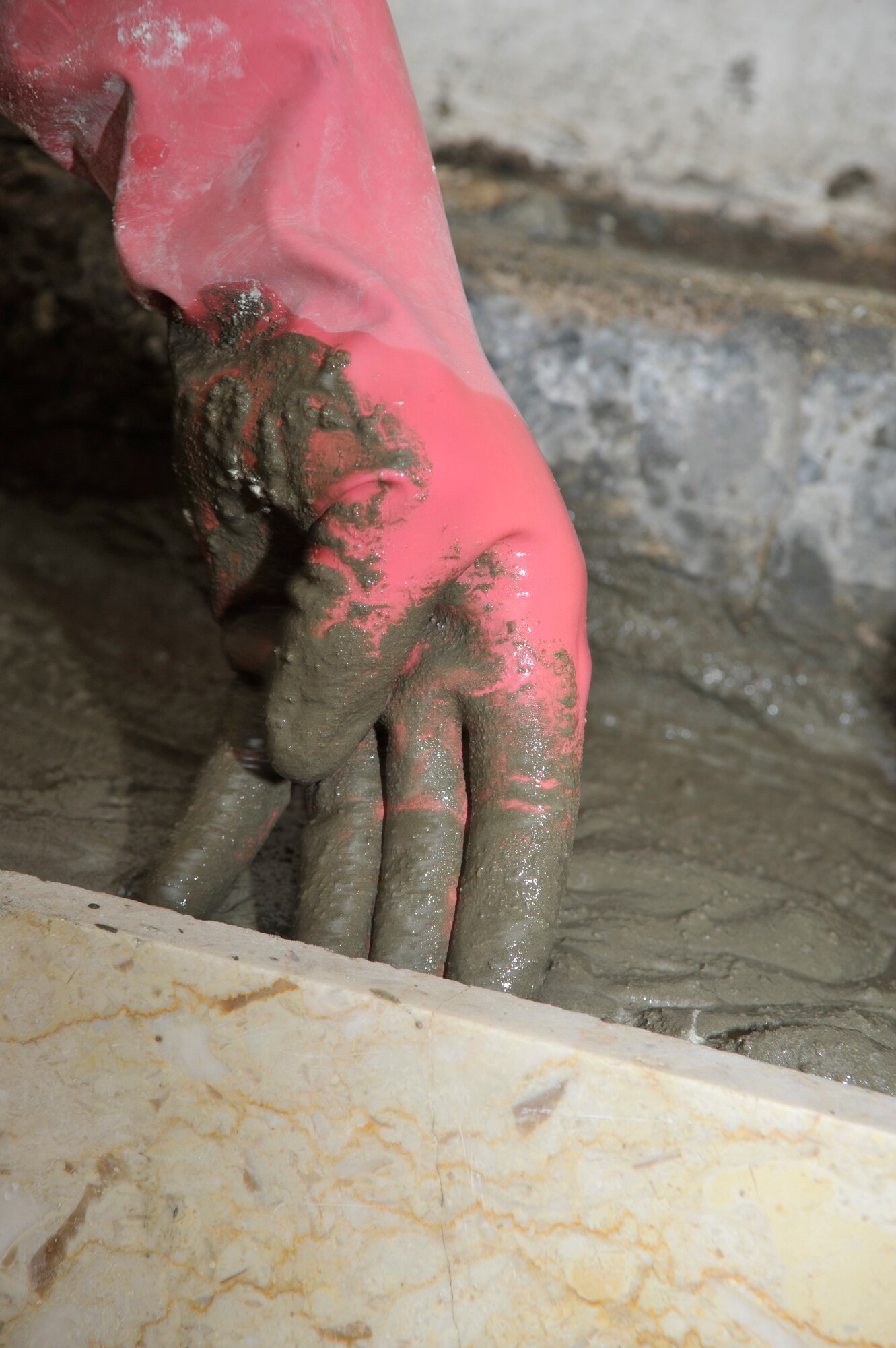 An Iraqi construction worker lays concrete for a step at a facility on Forward Operating Base Union III, International Zone, Baghdad, Iraq, Jan. 29, 2010. (Air Force photo by Senior Master Sgt. Larry Schneck/Released)