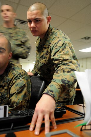 Sgt. Marcelino Mejia, Headquarters and Headquarters Squadron administrative separations noncomissioned officer in charge, helps Lance Cpl. Diego Gonzalez, H&HS administration specialist, at the Marine Corps Air Station in Yuma, Ariz. Mejia was meritoriously promoted Feb. 2, 2011, after being named the Marine Corps Installations-West Noncommissioned Officer of the Quarter recently. Mejia's Marines count working with him as one of their best experiences in the Corps. "Sgt. Mejia helps me in any and all problems I come across," said Gonzalez. "I know I can count on him with anything."