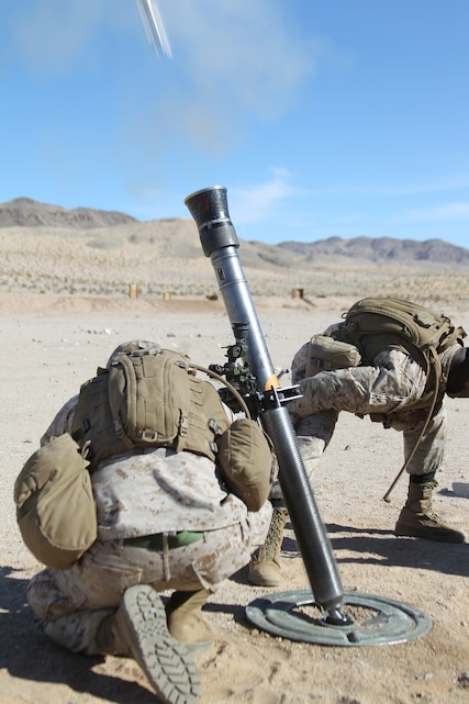 Marines send an 81mm mortar round downrange during an exercise designed to qualify forward observers at Range 106 Feb. 3, 2011.