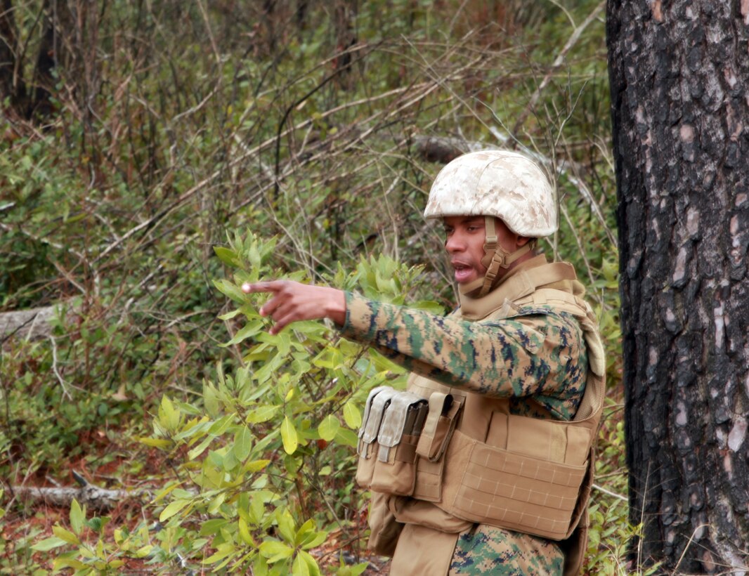 Lance Cpl. Victor M. Patterson, a team member with Personal Security Detail, 2nd Marine Logistics Group (Forward), points out a potential mock Improvised Explosive Device during a mine sweeping and IED awareness exercise held aboard Camp Lejeune, N.C., Feb. 3, 2011.  The Marines searched for possible IED and mine threats while conducting foot patrols simulating the same obstacles they may face in Afghanistan. (U.S. Marine Corps photo by Lance Cpl. Bruno J. Bego)