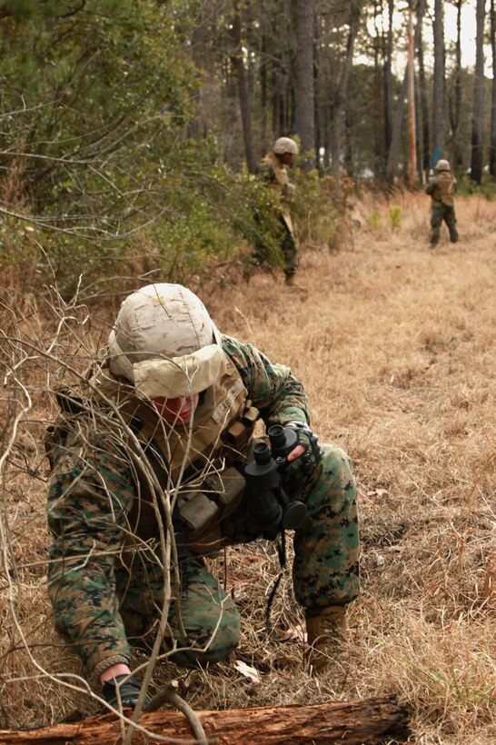 Cpl. Michael E. Gabriel, a team member with Personal Security Detail, 2nd Marine Logistics Group (Forward), investigates a potential mock Improvised Explosive Device during a mine sweeping and IED awareness exercise aboard Camp Lejeune, N.C., Feb. 3, 2011. The Marines searched for possible IED and mine threats while conducting foot patrols simulating the same obstacles they may face in Afghanistan. (U.S. Marine Corps photo by Lance Cpl. Bruno J. Bego)