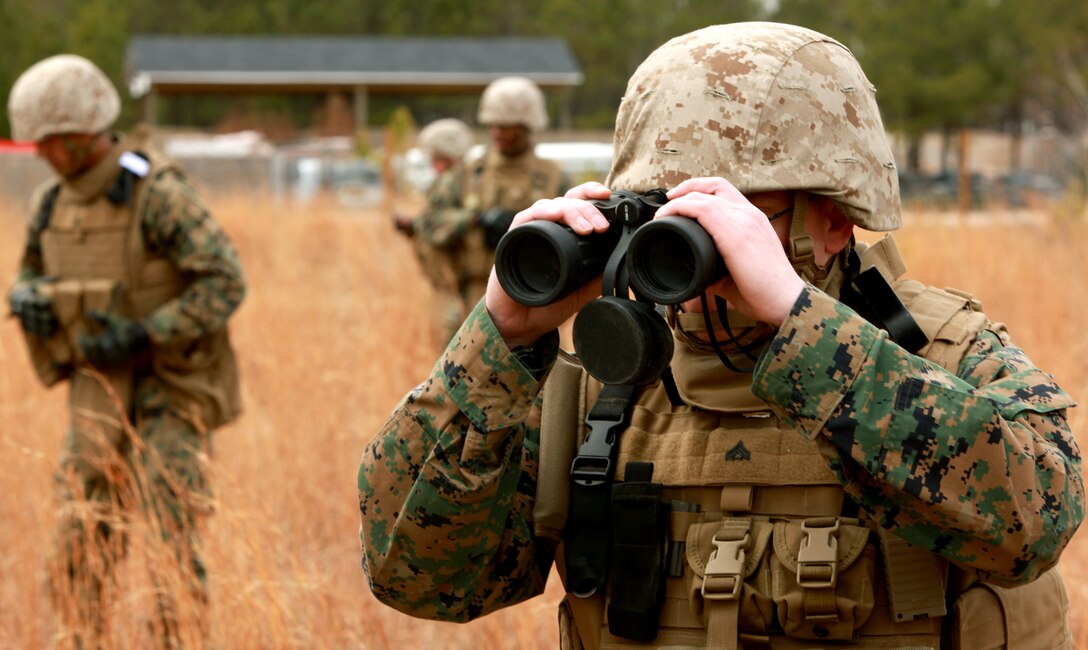 Cpl. Gregory A. Cadnallader, a team member with Personal Security Detail, 2nd Marine Logistics Group (Forward), searches for potential mock Improvised Explosive Devices during a mine sweeping and IED awareness exercise aboard Camp Lejeune, N.C., Feb. 3, 2011. The Marines searched for possible IED and mine threats while conducting foot patrols simulating the same obstacles they may face in Afghanistan. (U.S. Marine Corps photo by Lance Cpl. Bruno J. Bego)