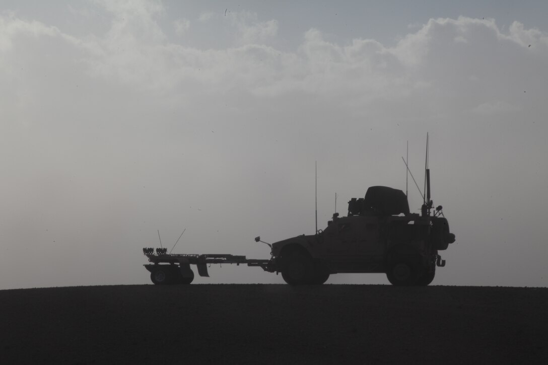 Marines in a Mine Resistant Armor Protected All-Terrain Vehicle (M-ATV) provide security atop a hill near Combat Outpost Ouellette,  Helmand province, Afghanistan, Feb. 3, 2011. Elements of the 26th Marine Expeditionary Unit deployed to Afghanistan to provide regional security in Helmand province in support of the International Security Assistance Force.