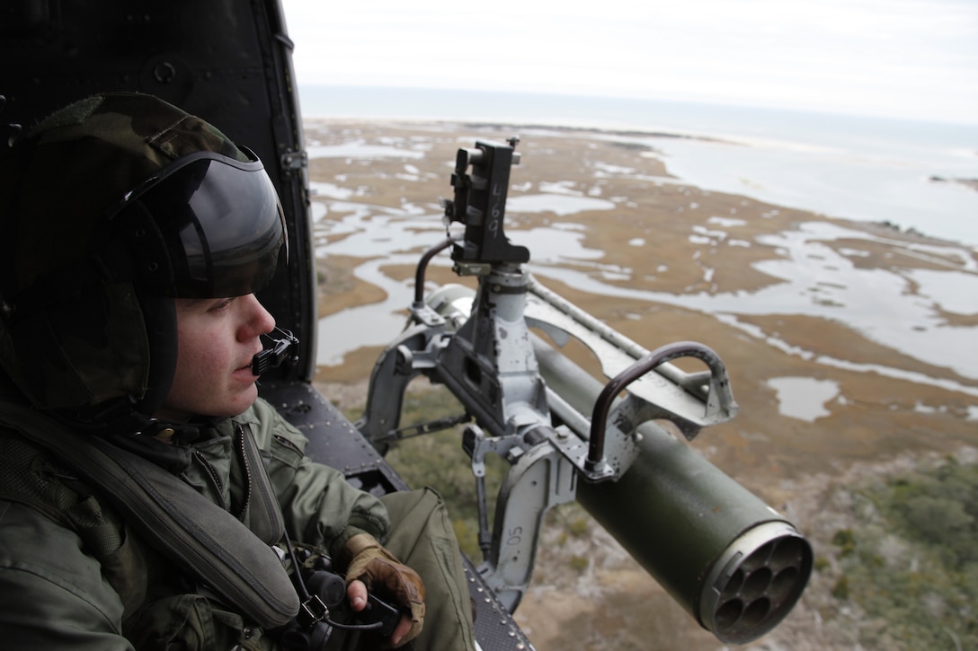 Lance Cpl. Caleb M. Morris, crew chief with Marine Light Attack Helicopter Squadron 467, scans the Eastern Carolina sky from a UH-1N Huey during a flight Feb. 3. “I have a six-foot-wide door that allows me to look out on the world like most people won’t ever get to see – It’s pretty cool,” said Morris.