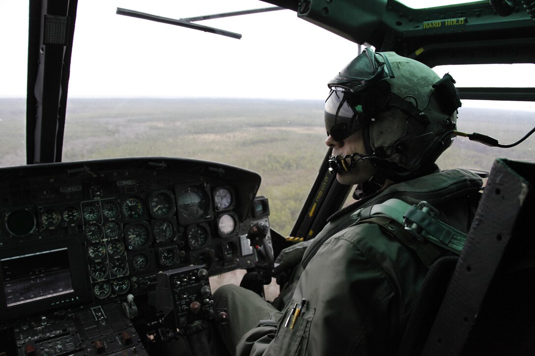Capt. Benjamin J. Beach, a UH-1N Huey pilot with Marine Light Attack Helicopter Squadron 467, scans the Eastern Carolina sky from a Huey during a flight Feb. 3. During the flight, Beach and the other crewmembers practiced confined area landings, which are used to medically evacuate personnel or execute troop insertions.