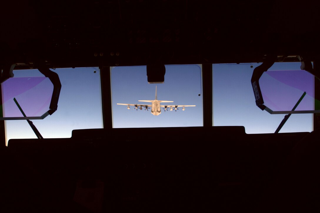 The pilot of a KC-130J positions his aircraft in the radar trail formation, flying behind and slightly below the lead plane, increasing the distance during inclement weather. The aircraft are assigned to Marine Aerial Refueler Transport Squadron 152, Marine Aircraft Group 36, 1st Marine Aircraft Wing, III Marine Expeditionary Force.