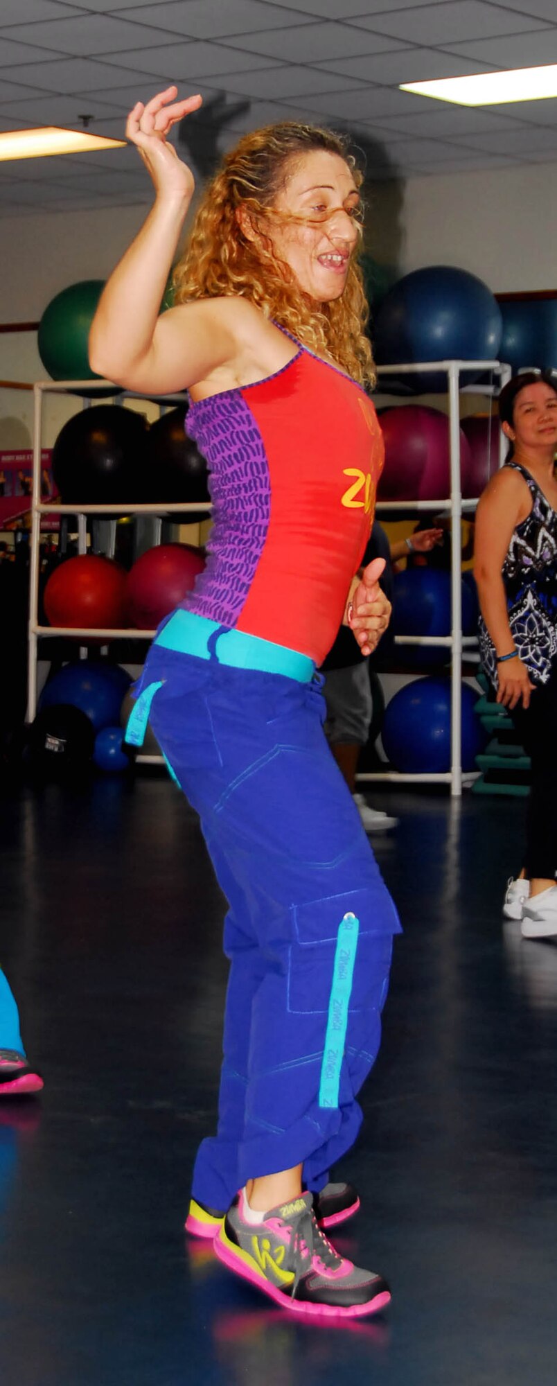 Rocio Sakai, a Zumba instructor at the Coral Reef Fitness Center here, demonstrates dance moves for her class during a Zumba session Jan. 27. Zumba, a popular work-out program, fuses Latin and international music into an hour-long, cardio-packed fitness experience. Zumba is offered at the CRFC Mondays, Wednesdays and Thursdays at 7 p.m., Tuesdays and Thursdays at 9:30 a.m. and Fridays at 5 p.m. (U. S. Air Force photo by Airman Fist Class Whitney Tucker)