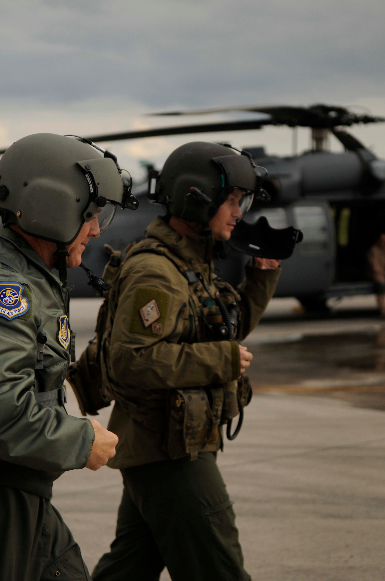 Lt. Gen. Burt Field, U.S. Forces, Japan and 5th Air Force commander (left), walks out to an HH-60 Pave Hawk helicopter with Tech. Sgt. Michael Welles, 33rd Rescue Squadron aerial gunner, for a flight Feb. 1. During his flight, General Field received an aerial tour of military bases around the island. (U.S. Air Force photo/ Airman 1st Class Brooke P. Beers)
