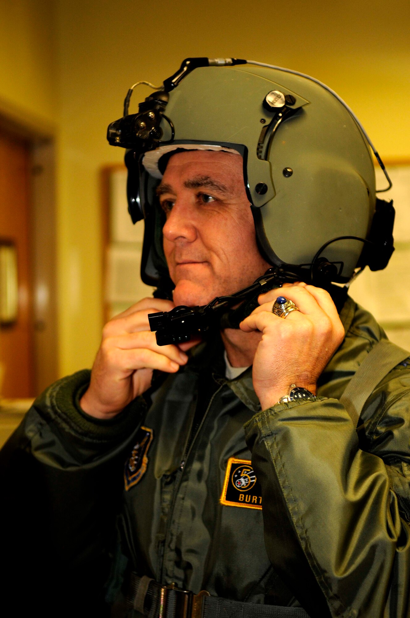 Lt. Gen. Burt Field, U.S. Forces, Japan and 5th Air Force commander, adjusts his helmet in preparation for an HH-60 Pave Hawk helicopter flight at Kadena’s 33rd Rescue Squadron, Feb. 1. The squadron provided General Field with an aerial tour of the military bases on Okinawa. (U.S. Air Force photo/ Airman 1st Class Brooke P. Beers)